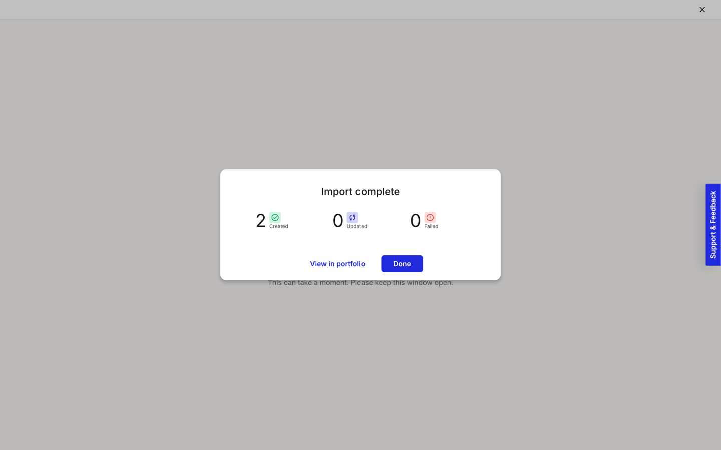 The Import complete dialog showing three counts: 2 Created, 0 Updated, 0 Failed, with View in portfolio and Done buttons.